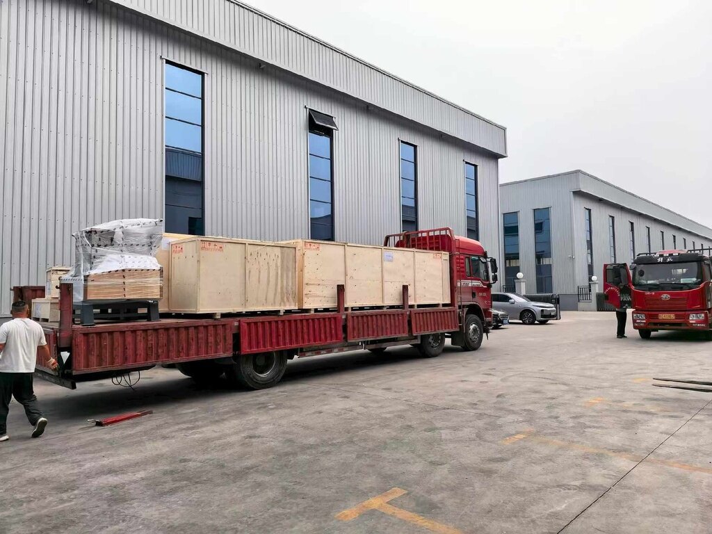 Wooden shipping crates loaded on a truck outside a workshop
