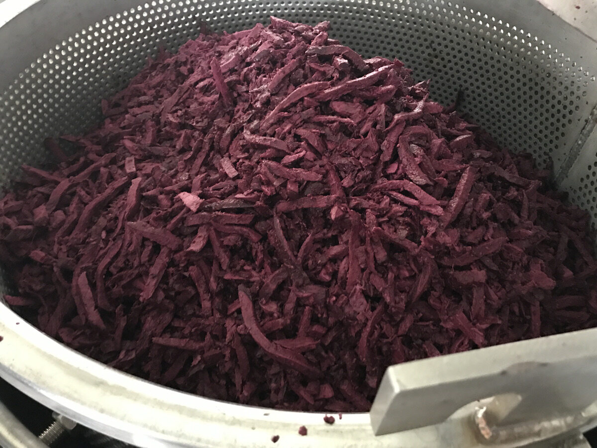 Prepared purple material in a perforated basket.