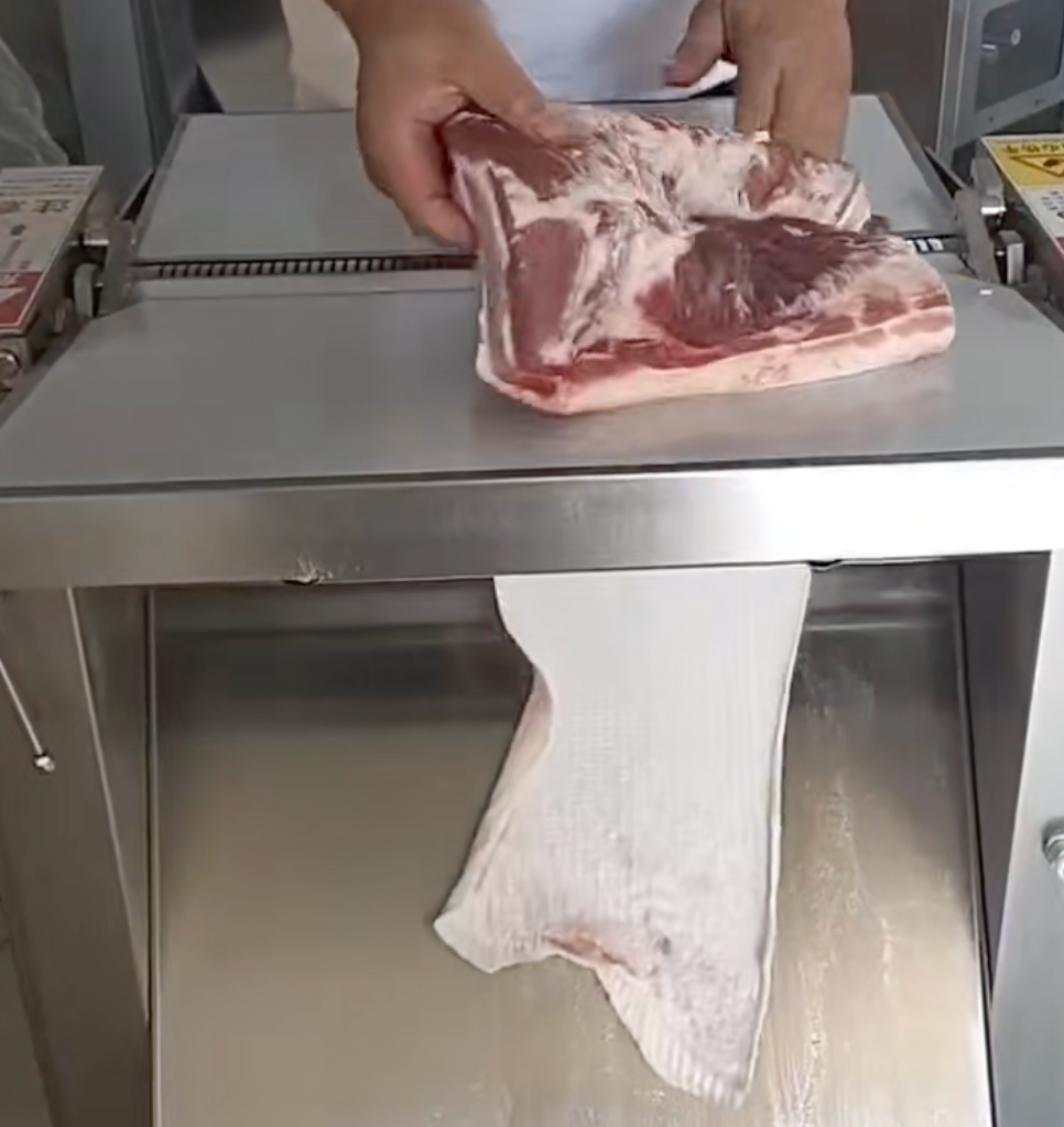 Pork skinning application showing separated skin below the feeding area