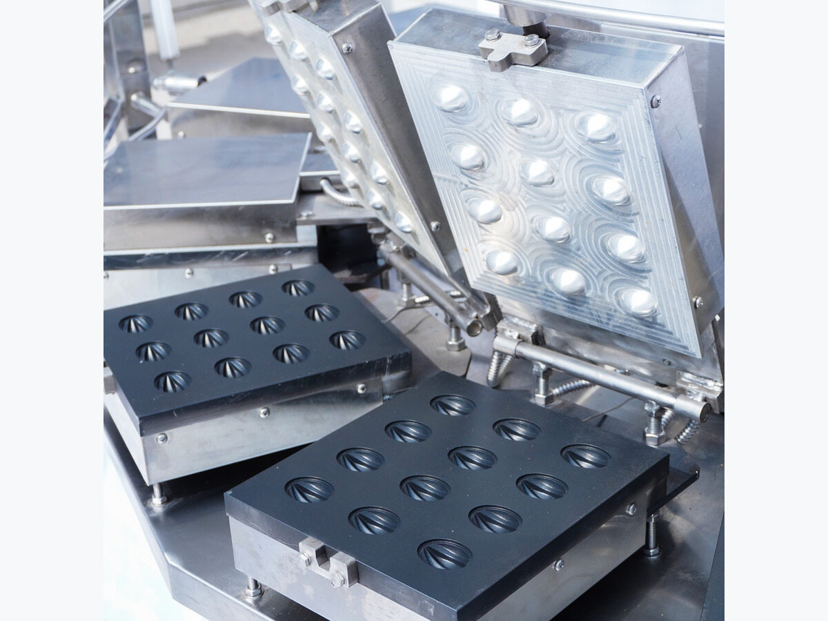 Walnut-shaped mould cavities on rotary mould plates.